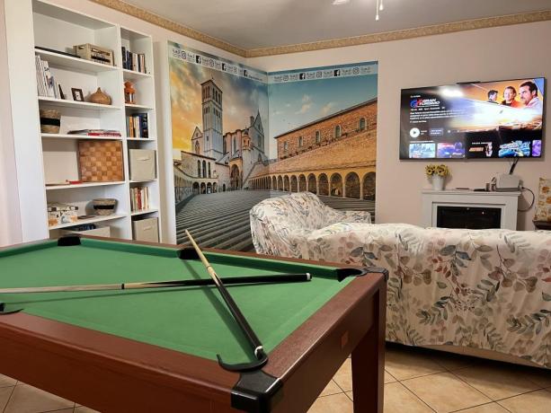 Large Living Room with Pool Table, 65" Smart TV, Fireplace, and Air Conditioning.